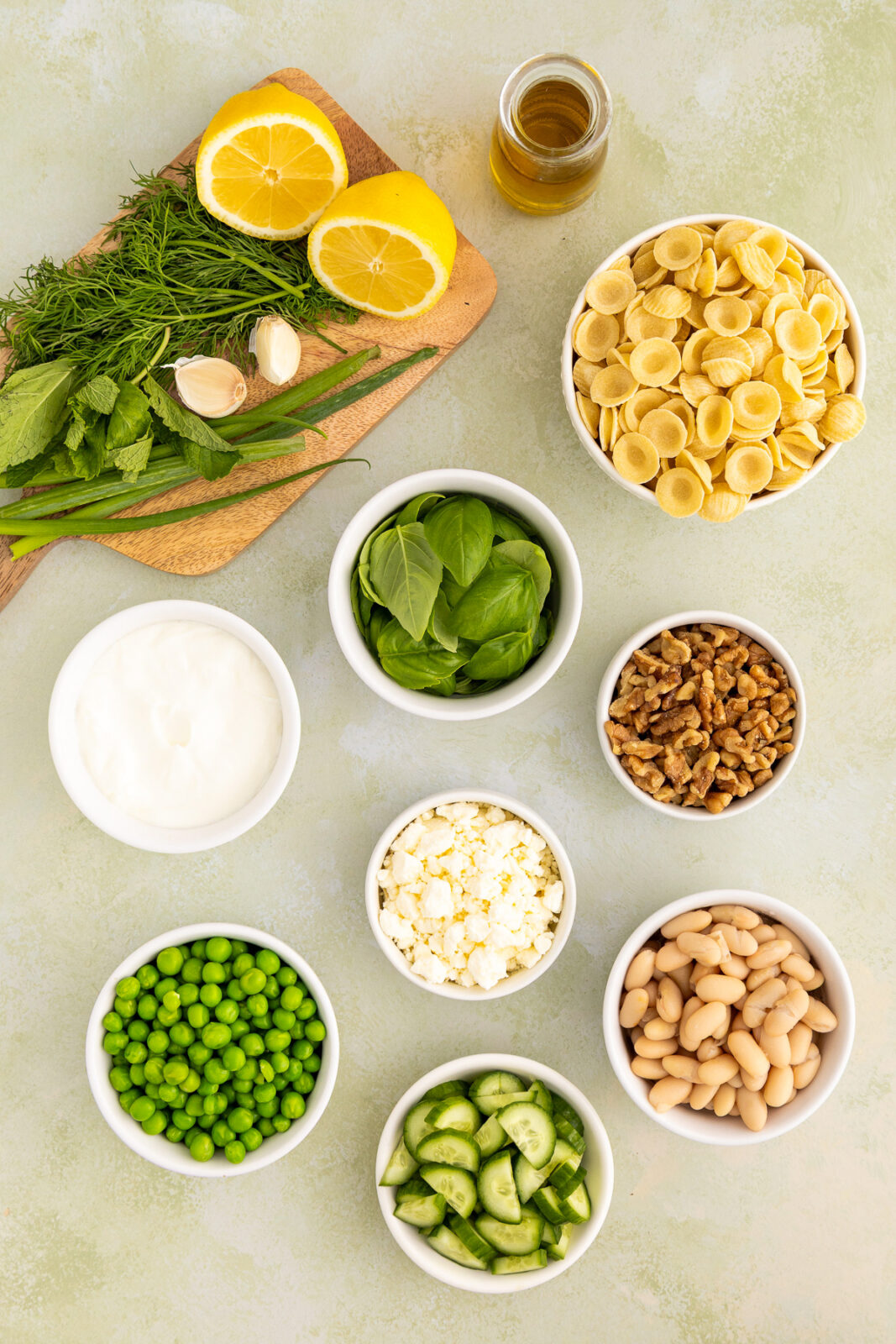 ingredients for a green goddess pasta salad in bowls