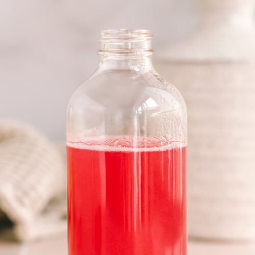 rhubarb simple syrup in a glass bottle