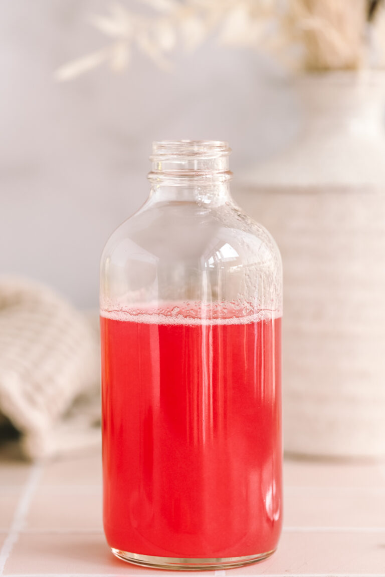 rhubarb simple syrup in a glass bottle