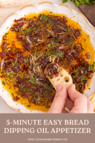 piece of bread dipped into loaded bread dipping oil
