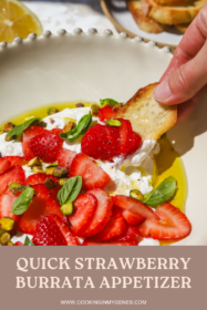 hand dipping crostini into strawberry burrata appetizer in a bowl
