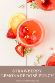 strawberry lemonade cocktail on a serving board with slices of lemons and strawberries