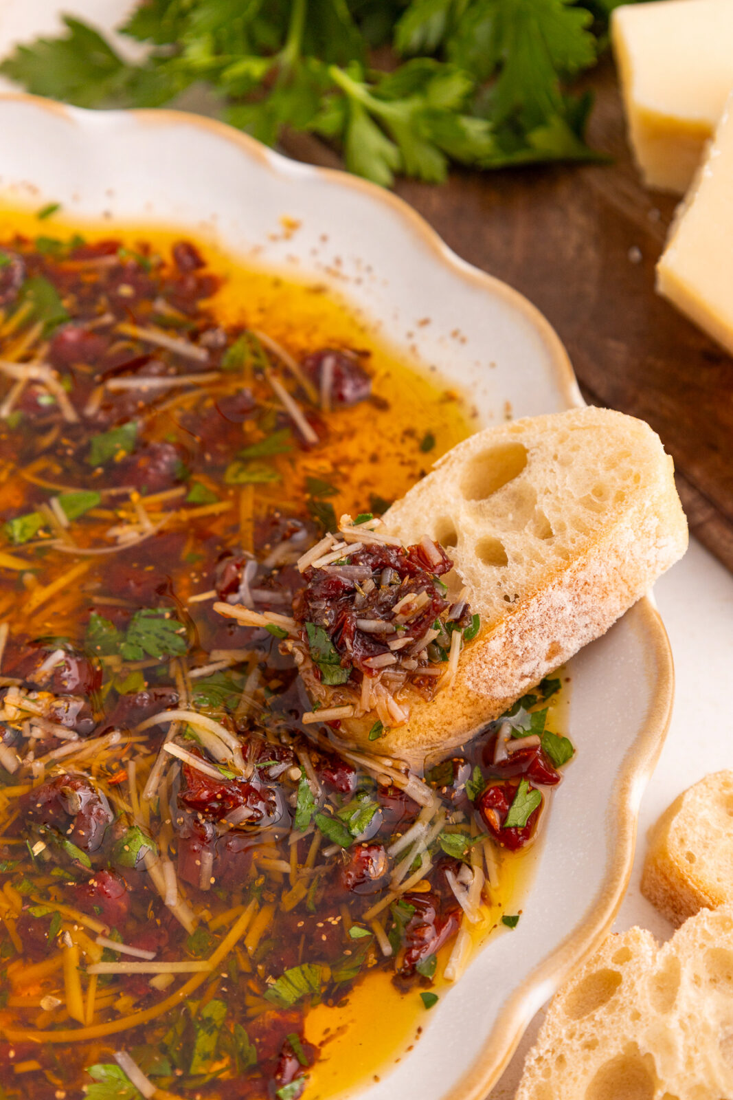 piece of bread dipped into loaded bread dipping oil