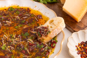 piece of bread dipped into loaded bread dipping oil