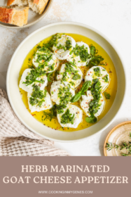 goat cheese marinated with fresh herbs, lemon, olive oil and garlic in a bowl