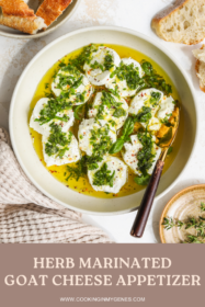 goat cheese marinated with fresh herbs, lemon, olive oil and garlic in a bowl with a serving knife