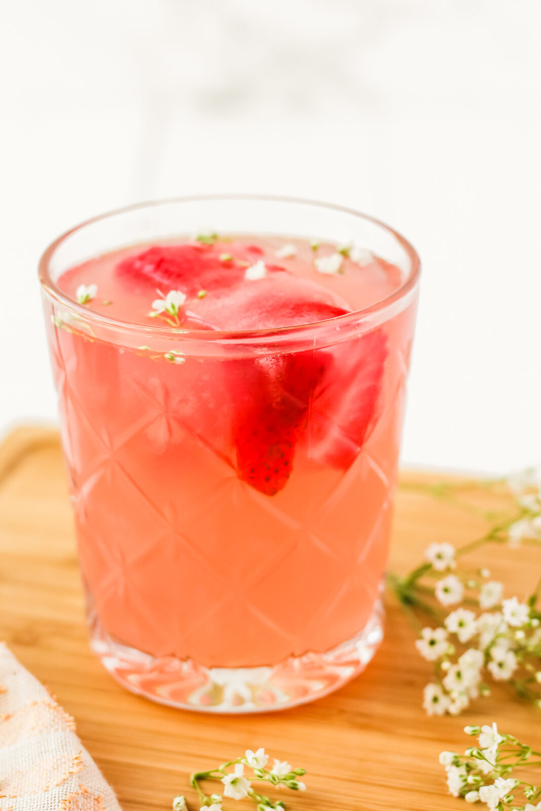 glass of strawberry rose lemonade cocktail