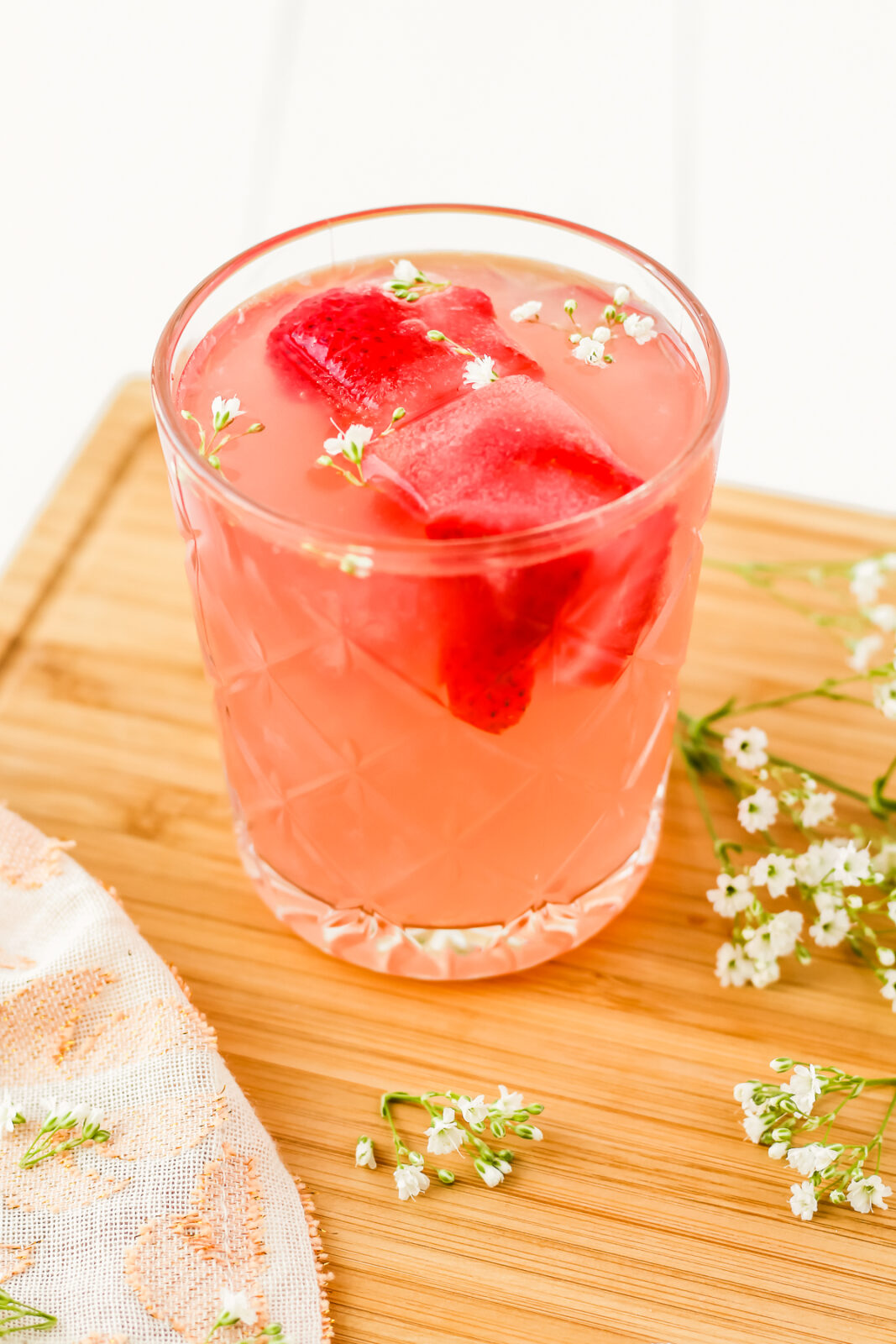 glass of strawberry rose lemonade cocktail