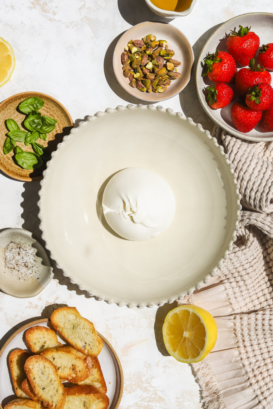 ball of burrata cheese surrounded by ingredients