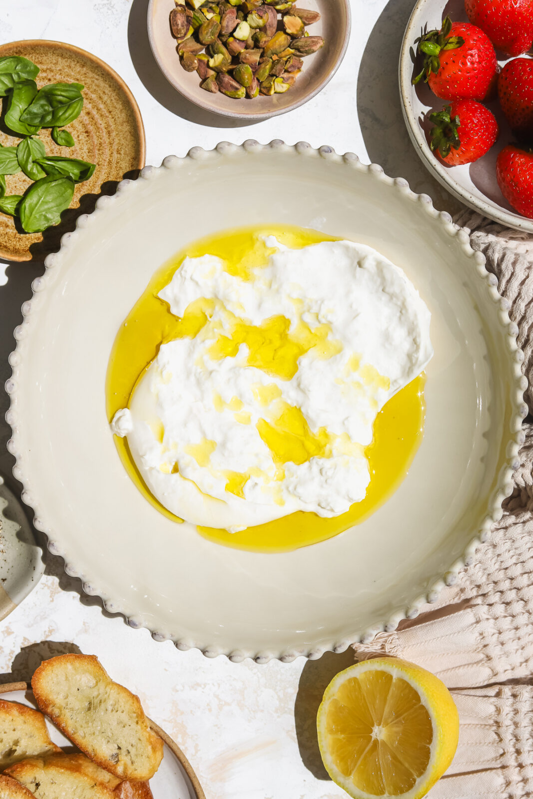 burrata torn up in a bowl and drizzled with olive oil