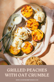 grilled peaches on a serving tray with scoops of ice cream and oat crumble