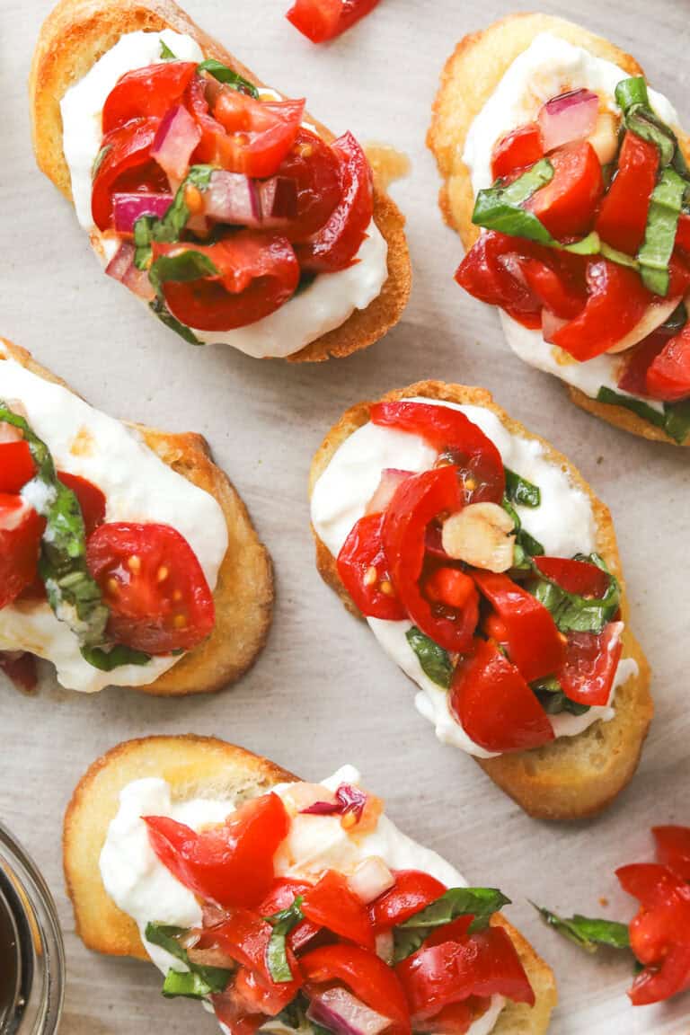 close up of bruschetta on a crostini with burrata