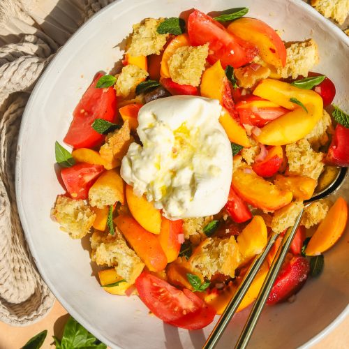 overhead photo of panzanella salad in a large bowl with burrata
