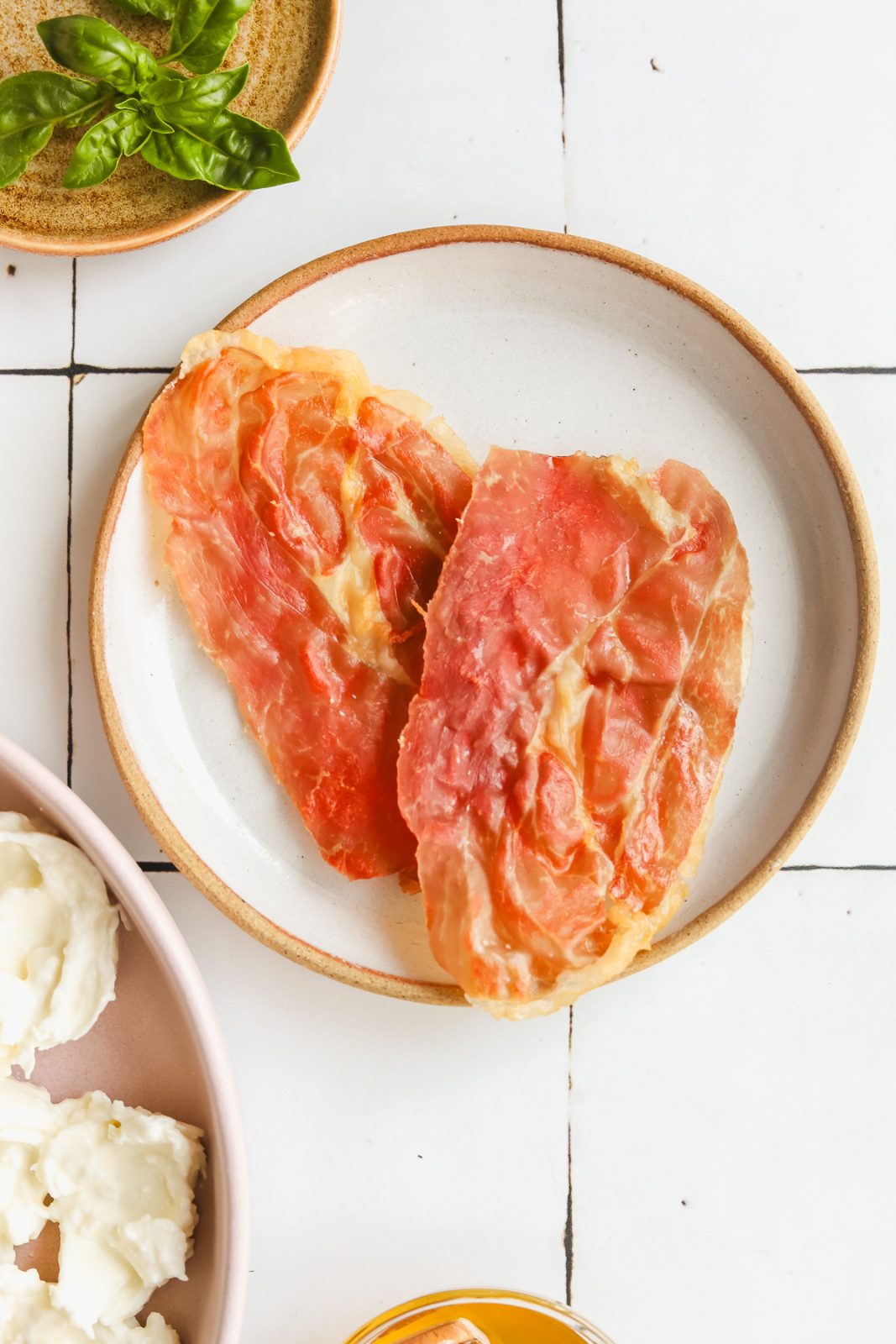 pieces of cooked prosciutto on a plate