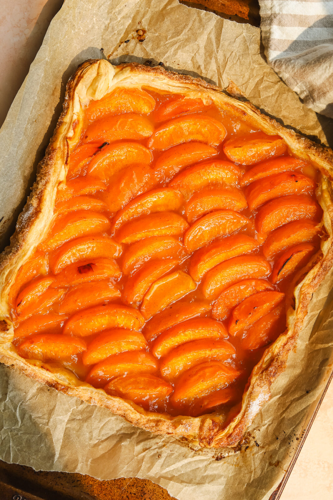 puff pastry apricot tart on a baking sheet