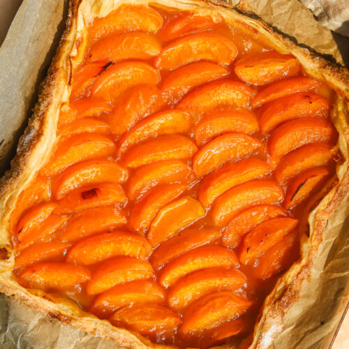 puff pastry apricot tart on a baking sheet