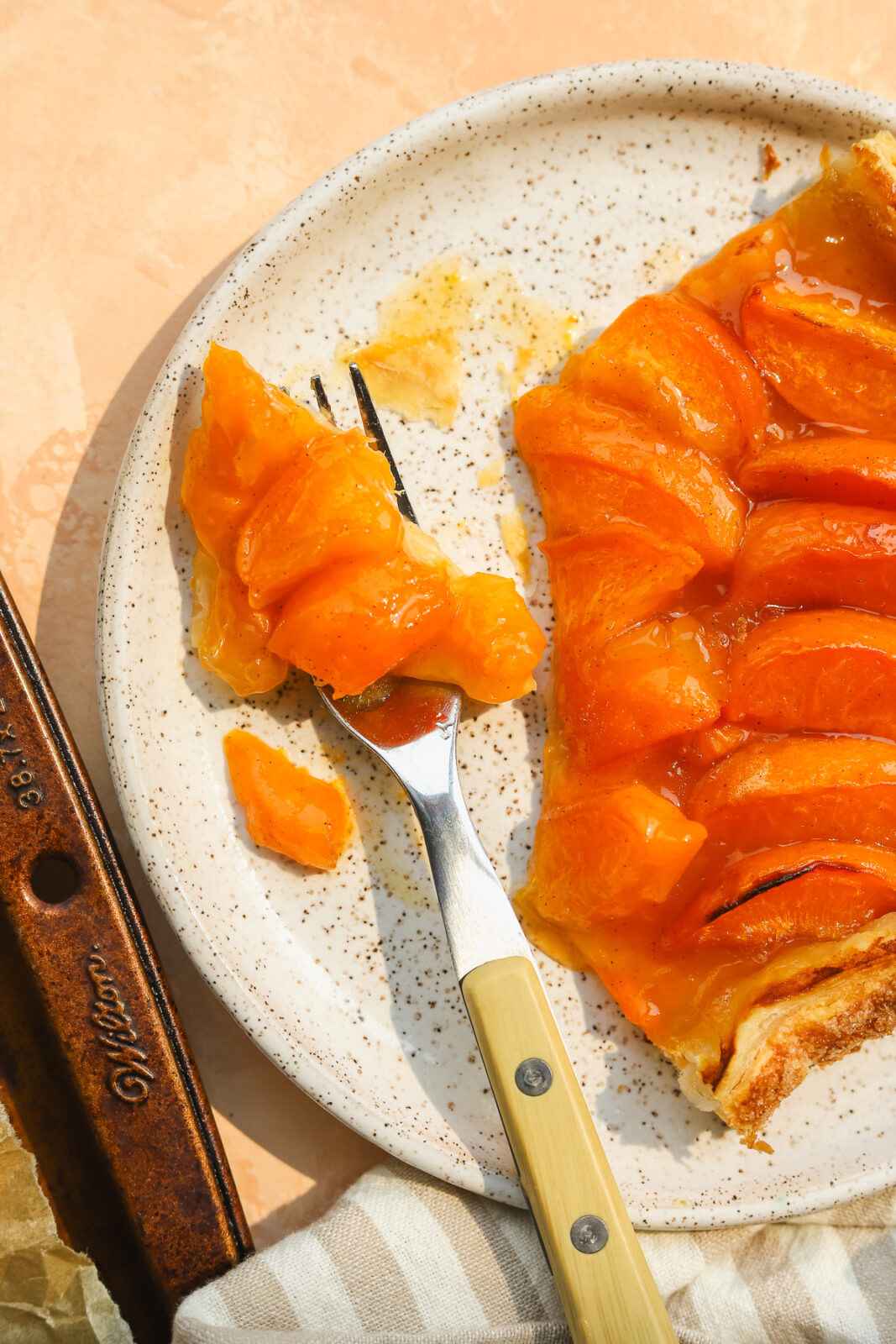 a fork with a piece of apricot tart on it