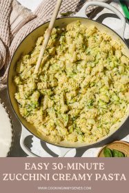 wooden spoon in a pot of creamy zucchini pasta