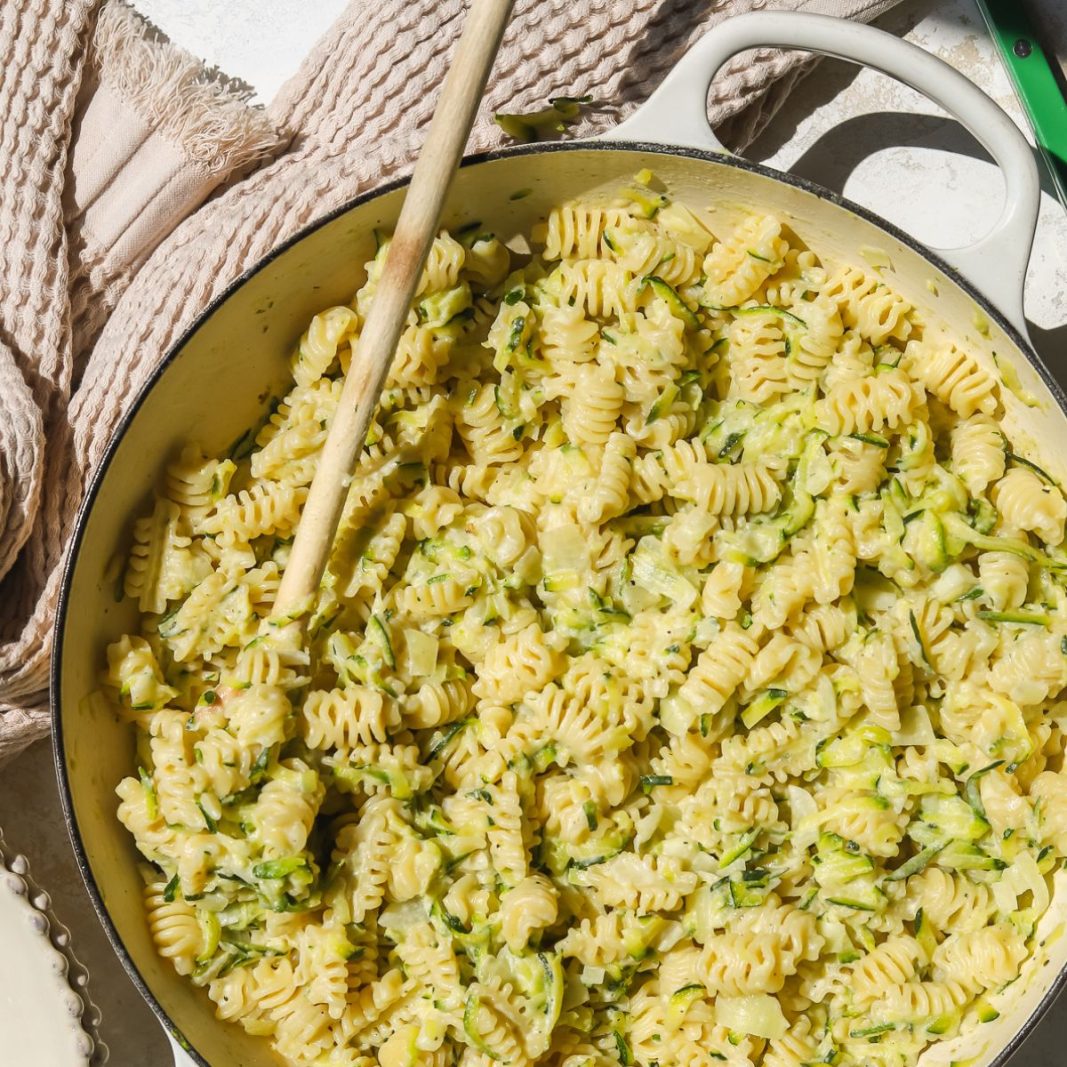 wooden spoon in a pot of creamy zucchini pasta