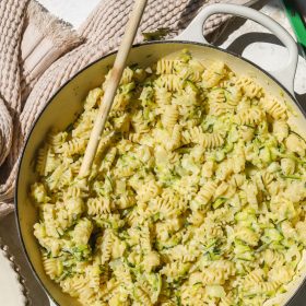 wooden spoon in a pot of creamy zucchini pasta