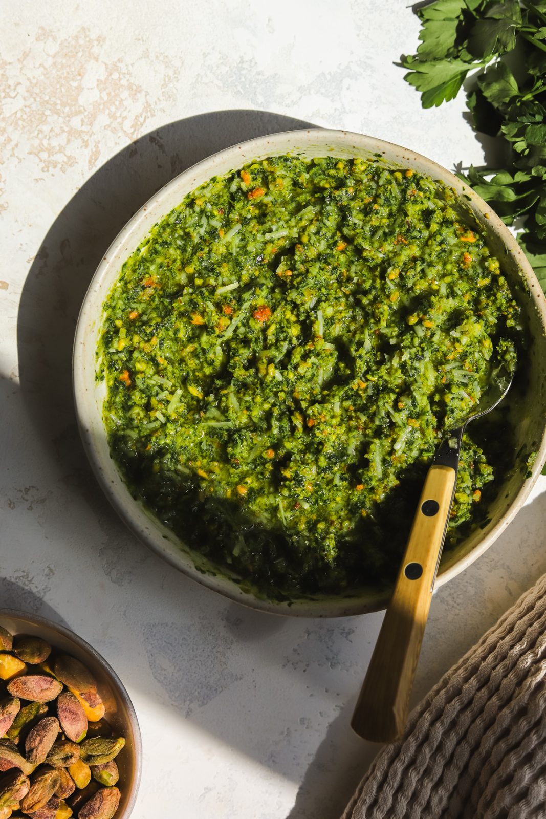 pistachio pesto in a bowl with a spoon
