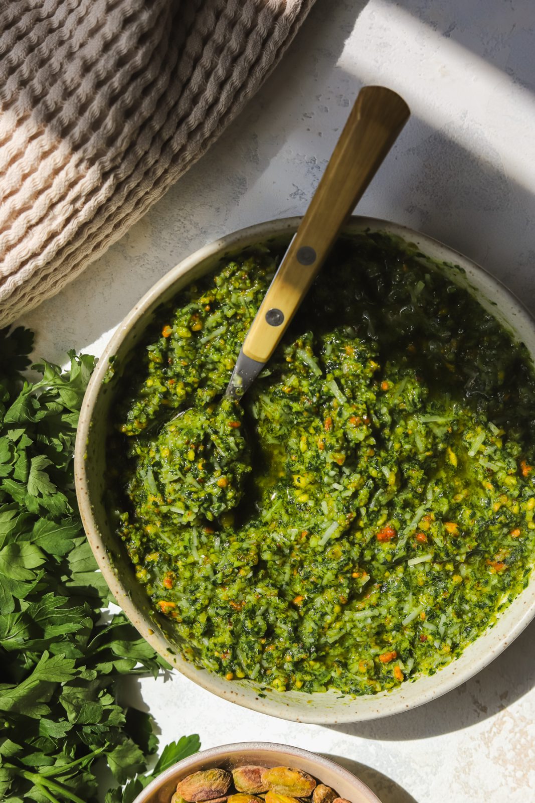 pistachio pesto in a bowl with a spoon