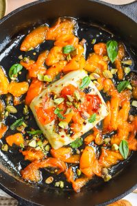 overhead photo of grilled halloumi with apricot slices in a cast-iron pan