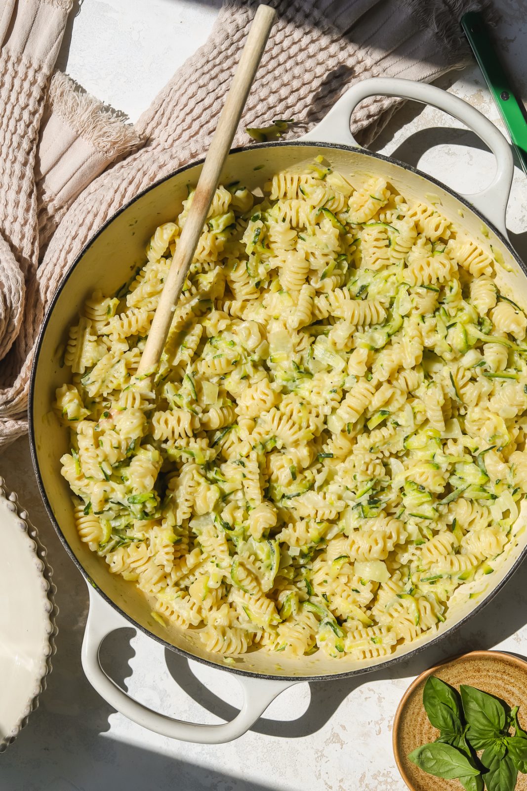 wooden spoon in a pot of creamy zucchini pasta