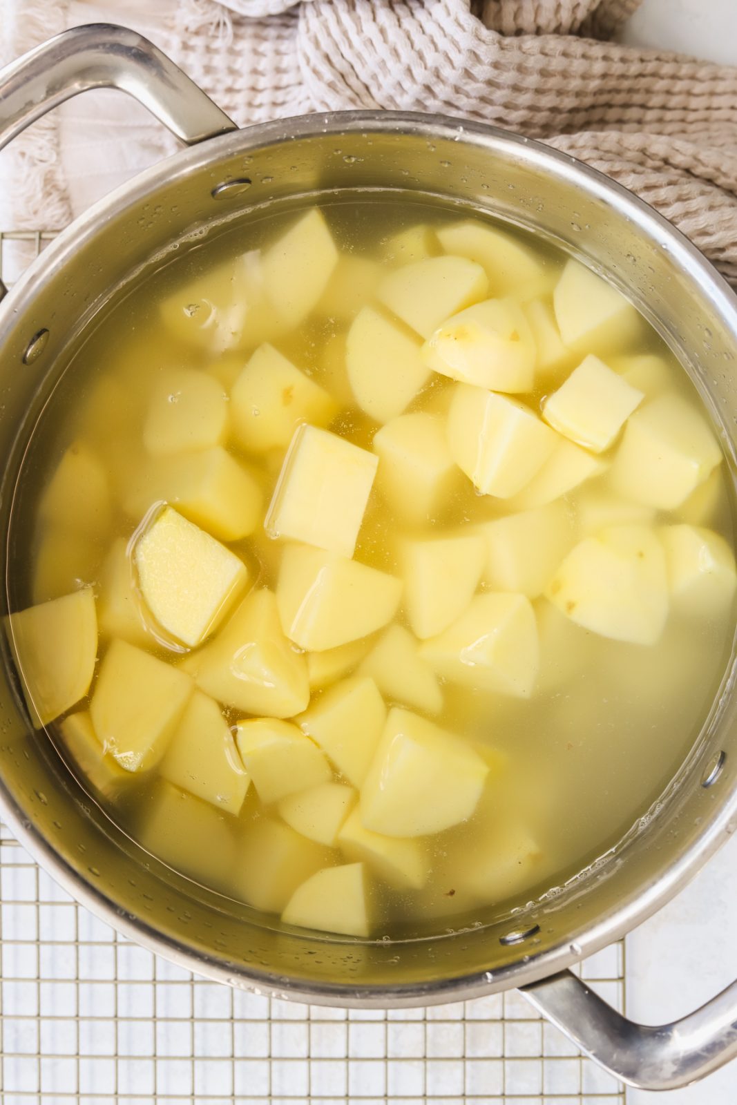 pieces of chopped potato in a pot of water