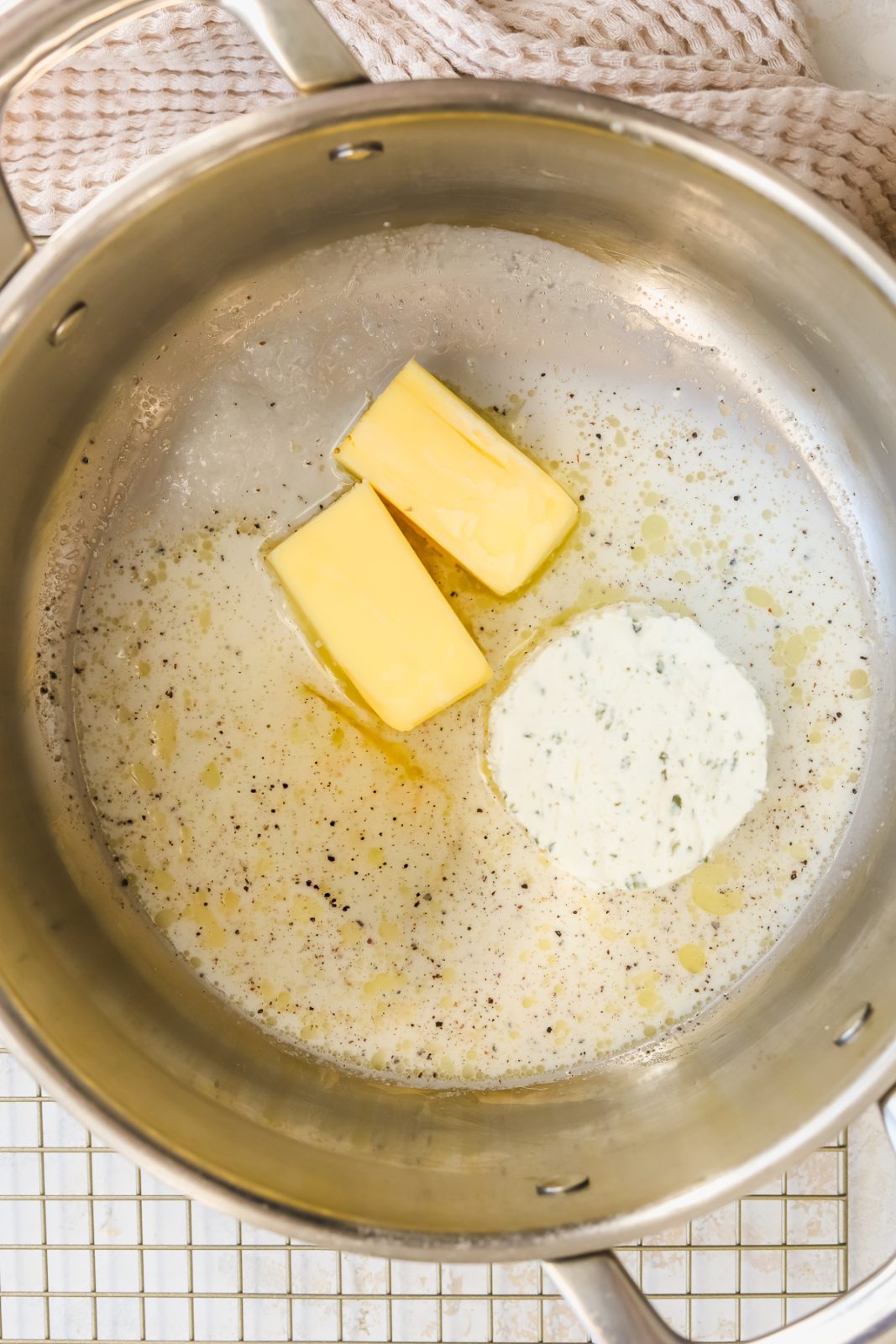 milk, butter and boursin cheese in a pot