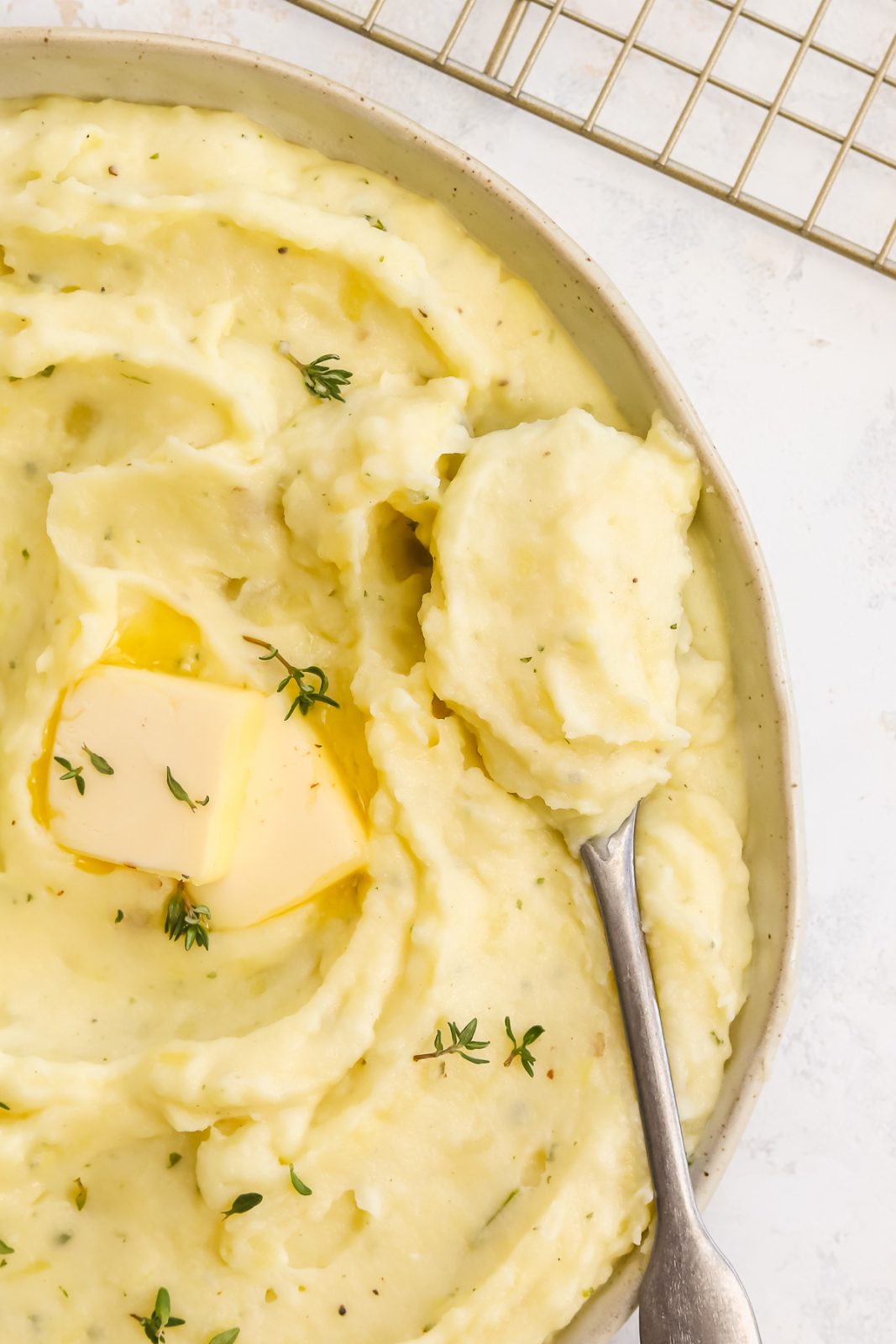 a spoonful of mashed potatoes sitting in a bowl