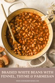 pot with braised white beans, sprigs of fresh thyme and a parmesan rind