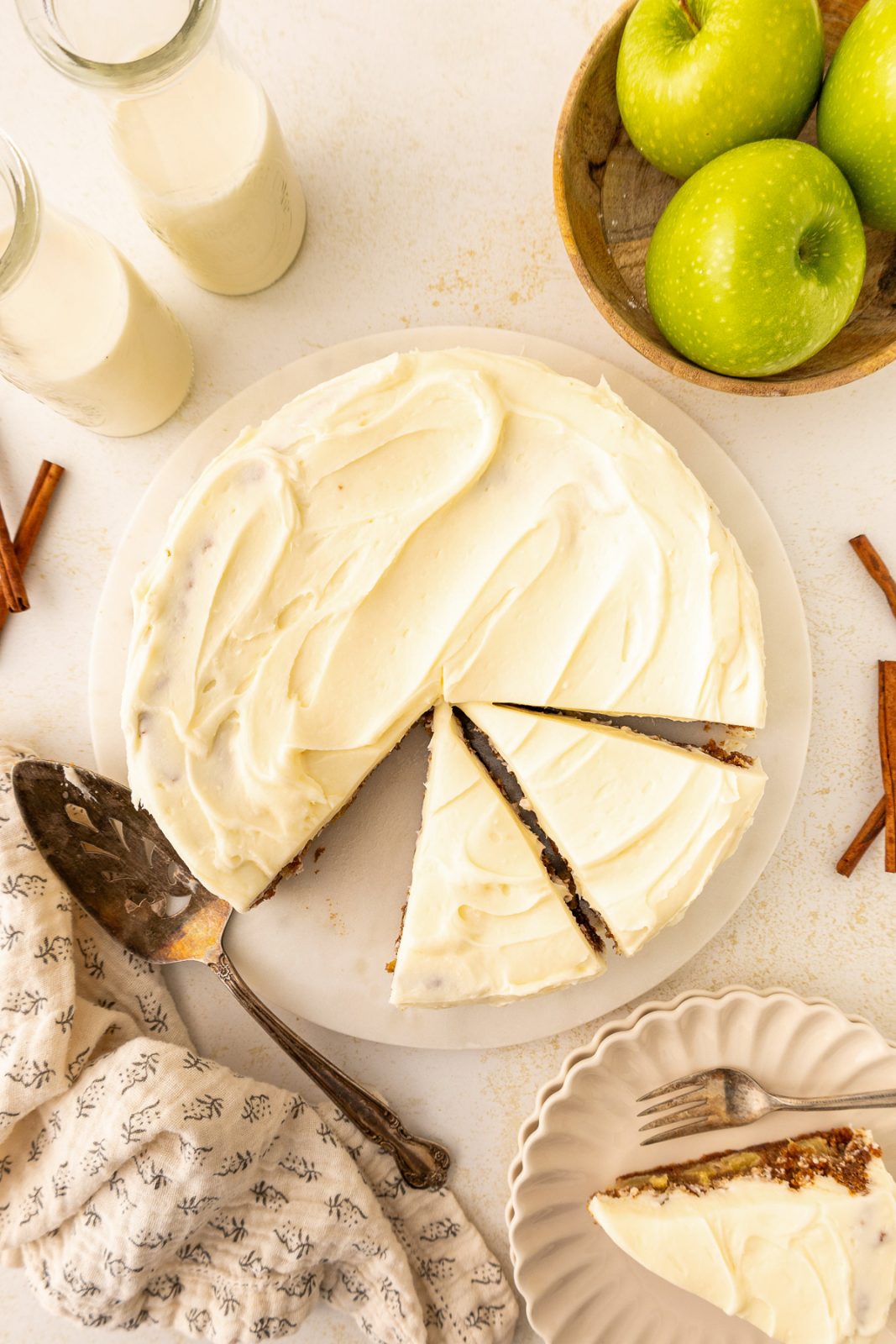 overhead photo of an apple cake with slices taken out of it