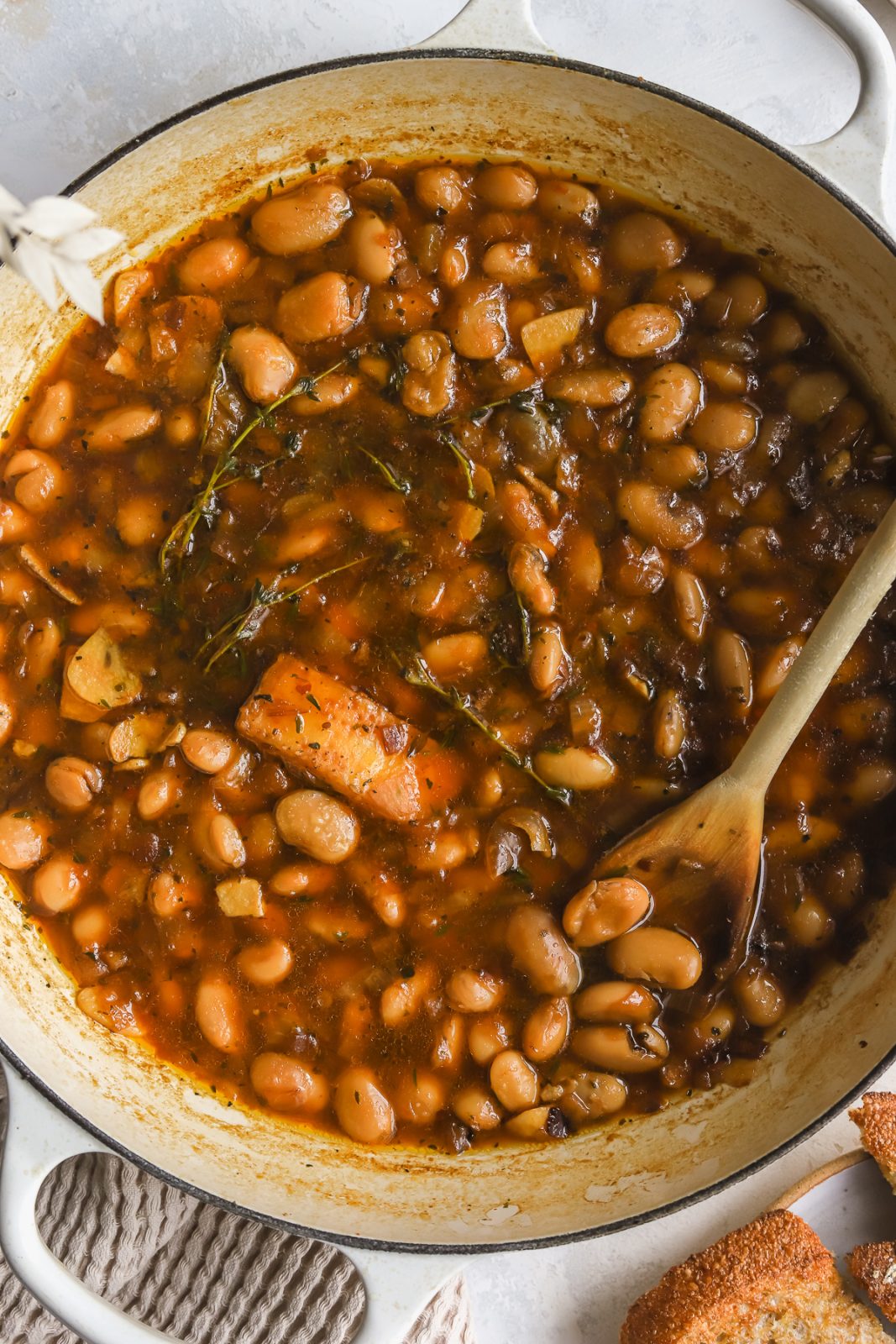 close up of braised white beans in a braiser