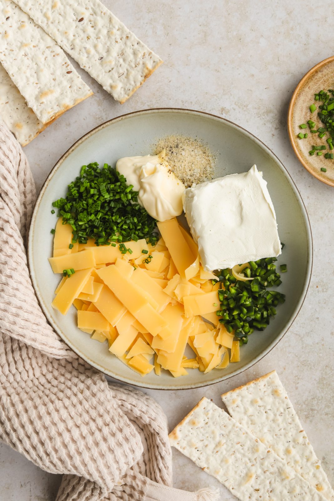 gouda cheese, spices, herbs and cream cheese in a bowl