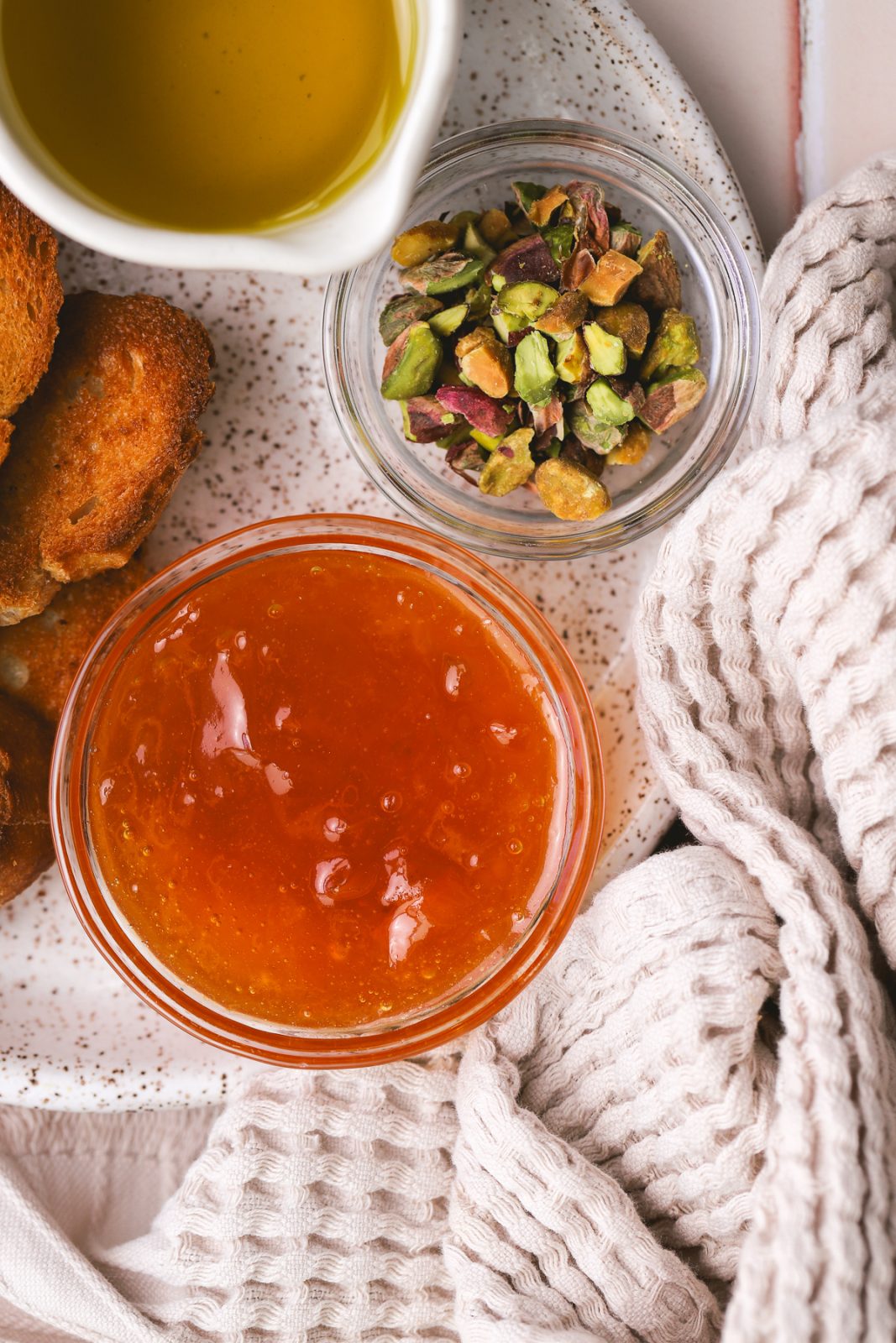 apricot jam in a bowl, chopped pistachios in a bowl