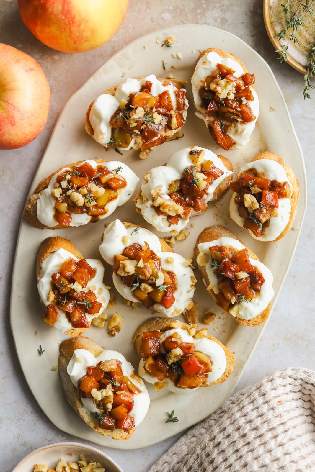 crostini with maple apples and whipped ricotta on a serving platter